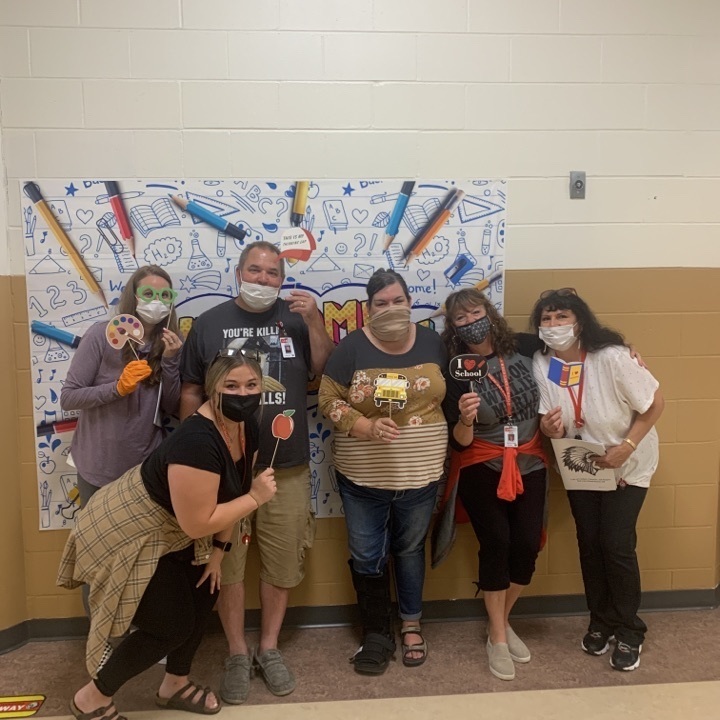 picture of staff in front of welcome back selfie backdrop