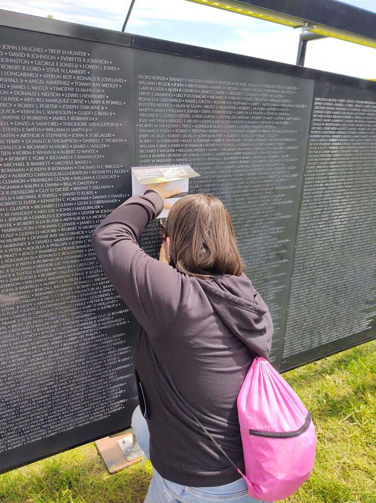 student looking at memorial wall